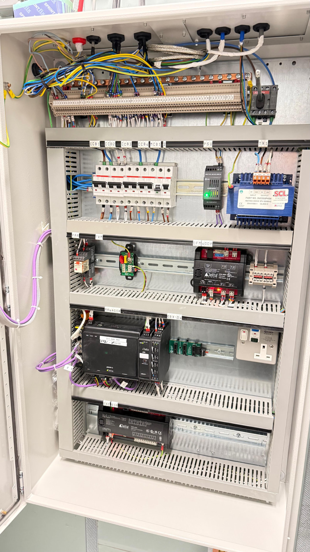 Sterling Controls BMS panel internals with labelled DIN rail, breakers and controllers